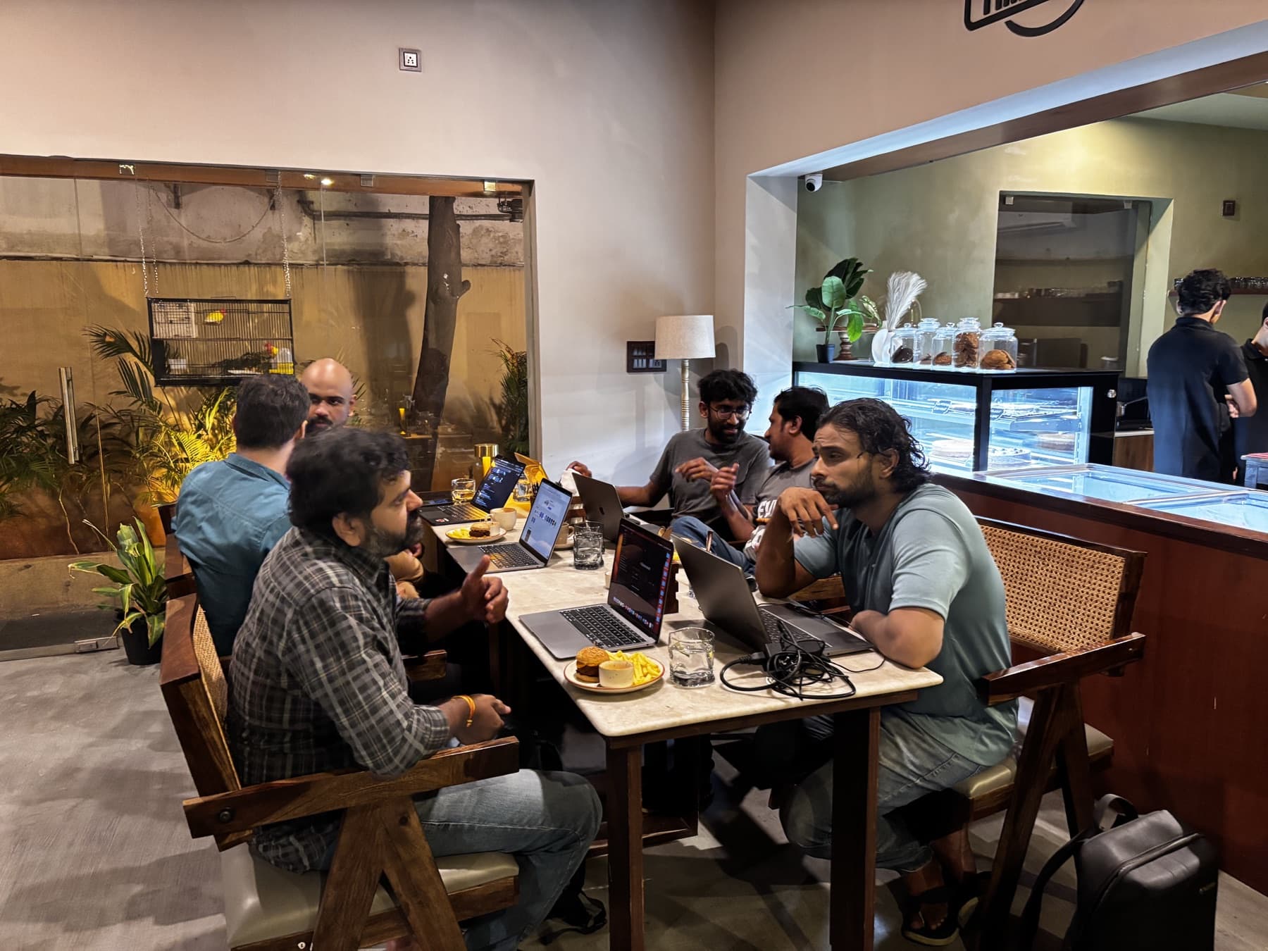 Warm cafe interior with team collaborative gathering around the table