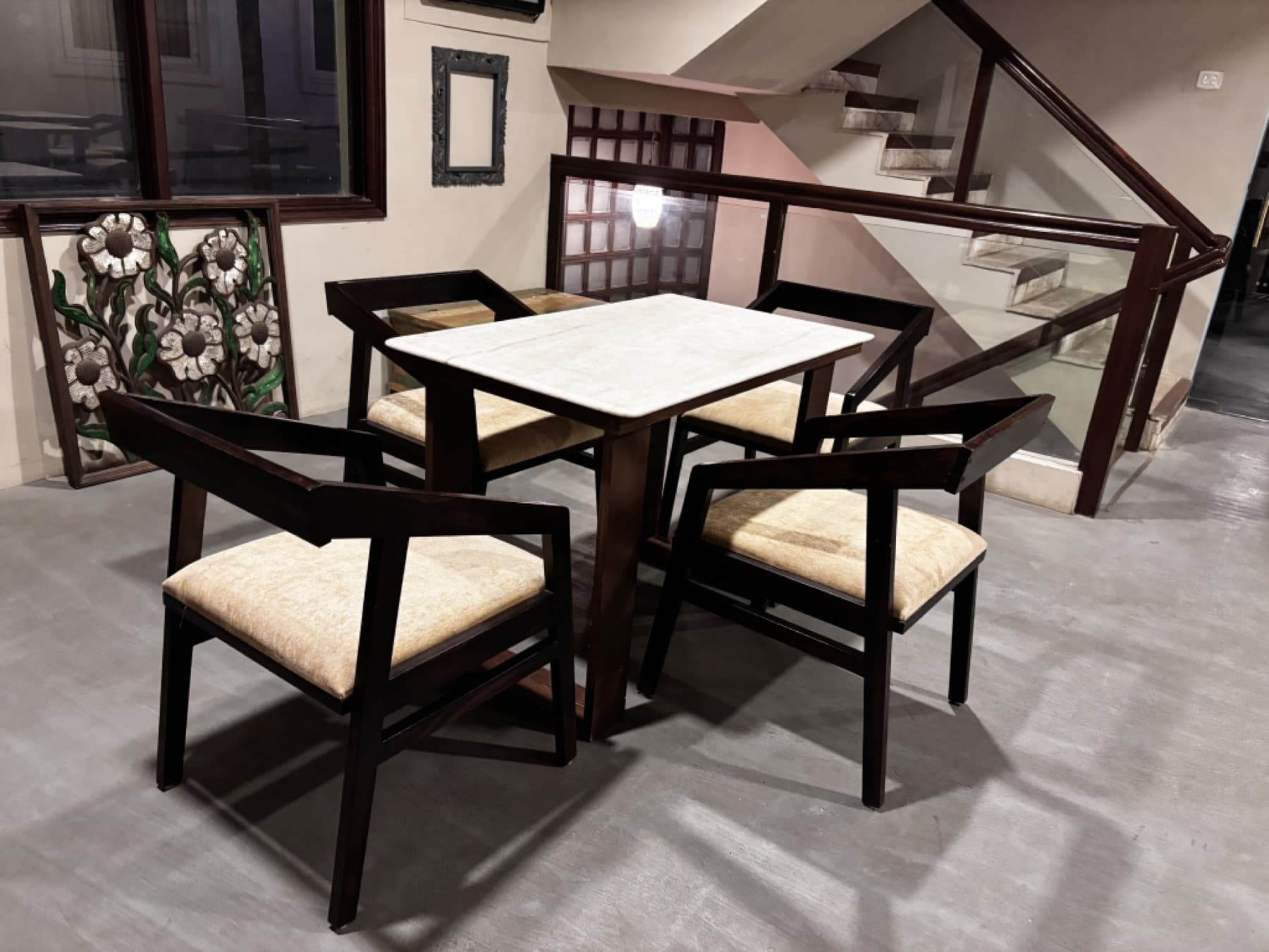 Conversation table with staircase railing and warm pendant fixture