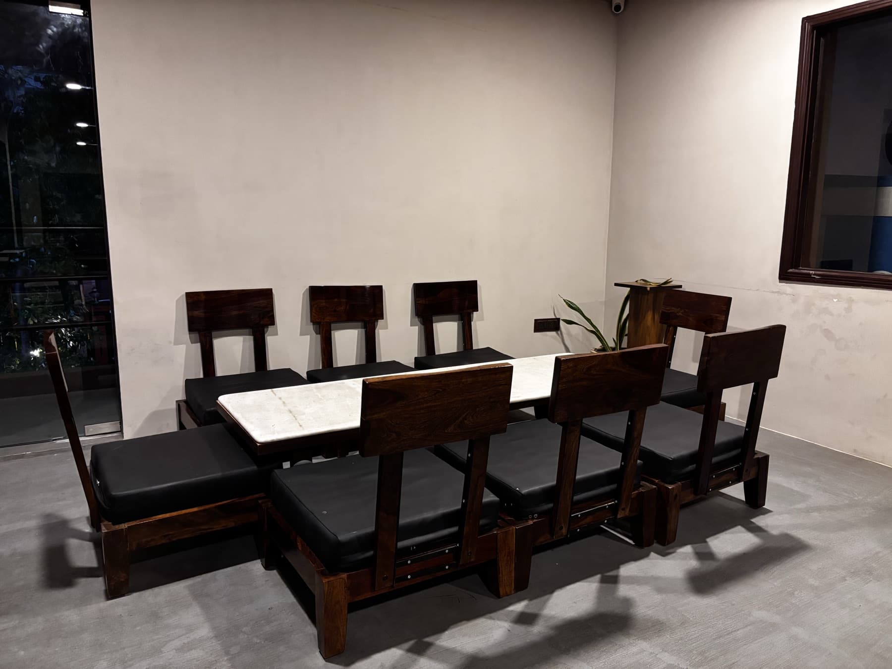 Side view of Korean table setup showing low wood-back chairs